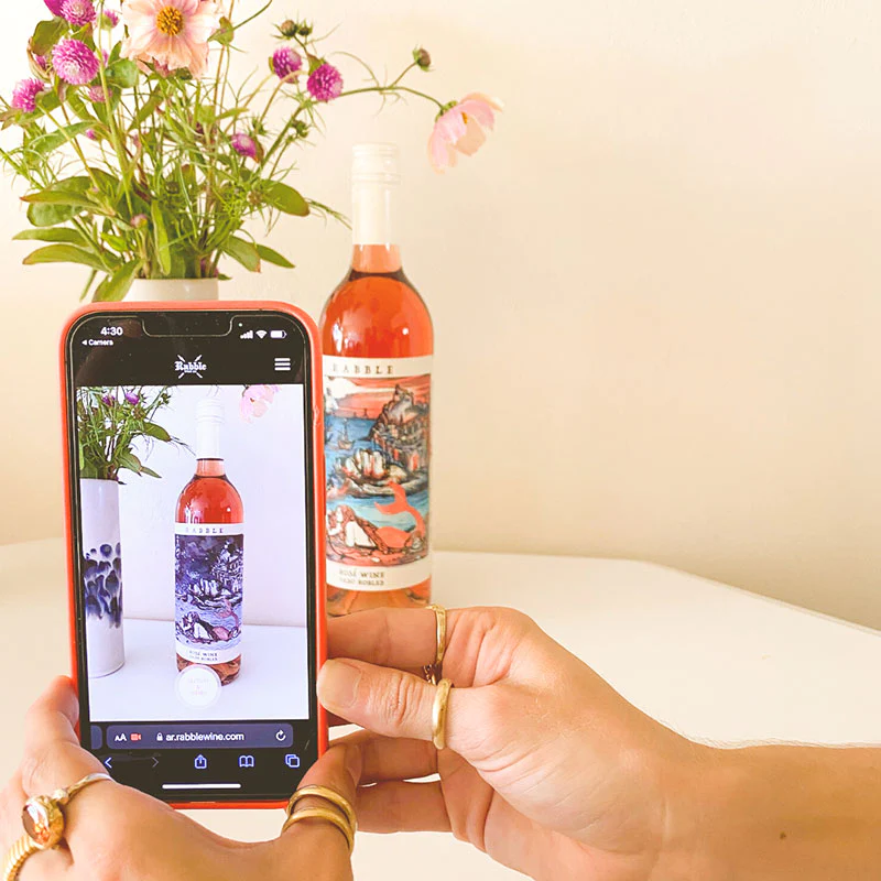 Phone scanning Rabble Wine bottle using Augmented Reality