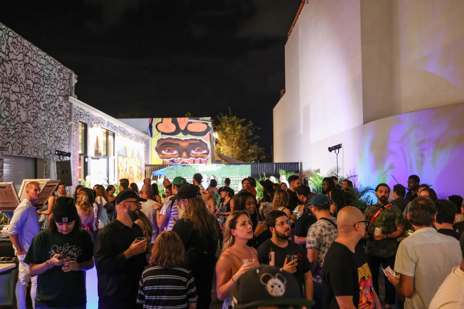 Guests gather among murals at Rabble’s Museum of Graffiti event in Miami.