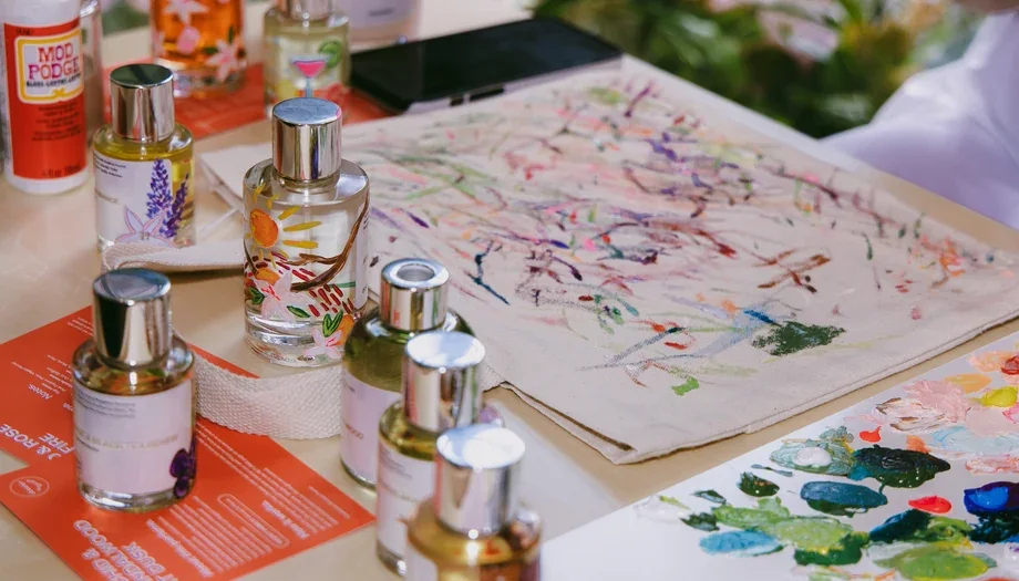 Fragrance bottles and creative materials at the live personalization table.