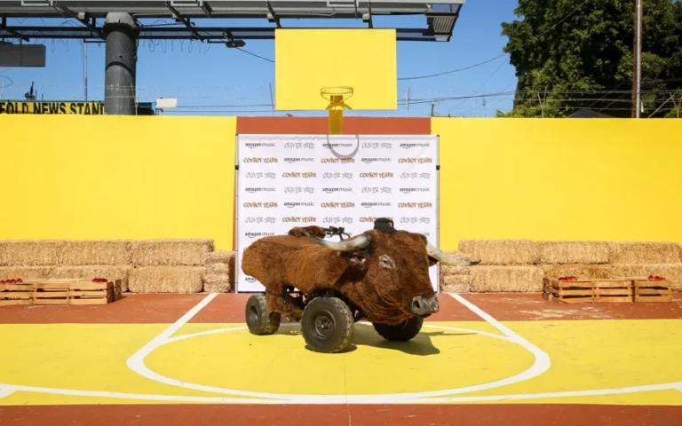 A bull-shaped vehicle on a yellow basketball court at Oliver Tree’s Cowboy Tears activation.