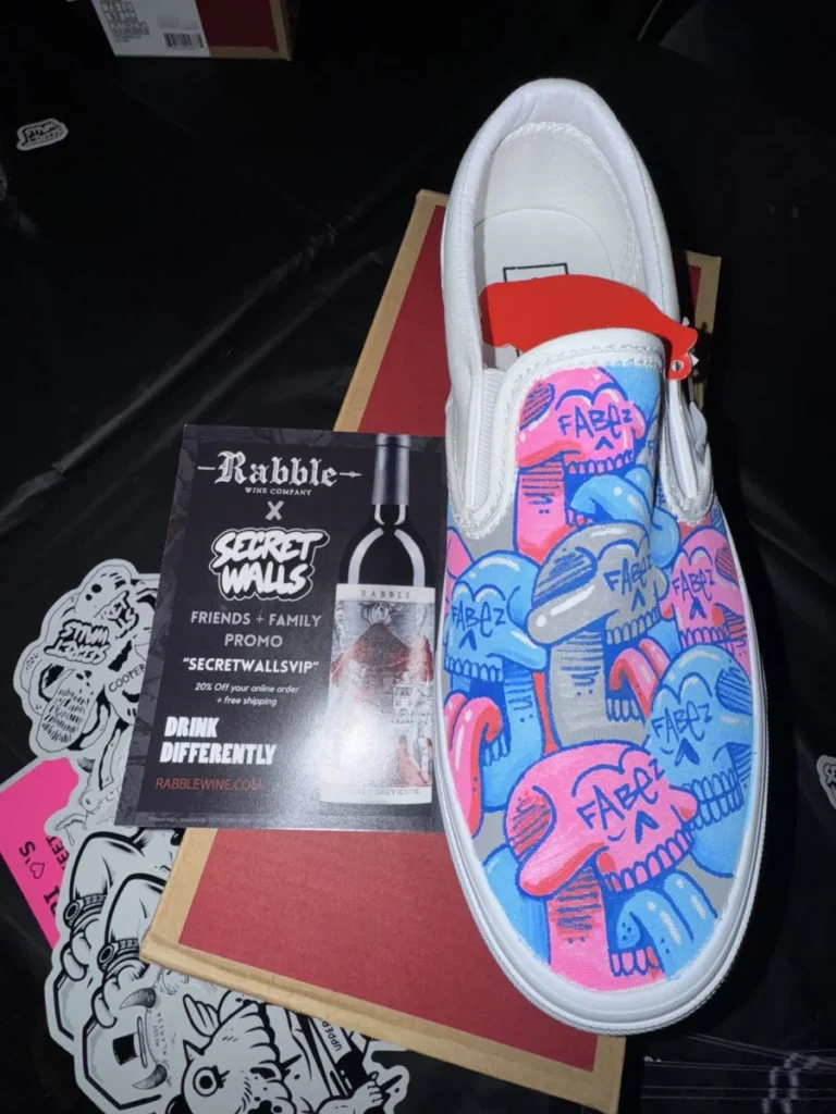 Custom-painted footwear beside Rabble and Secret Walls marks.