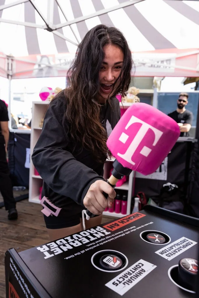 A guest takes a swing at Whack an ISP on Santa Monica Pier. Courtesy of T-Mobile.