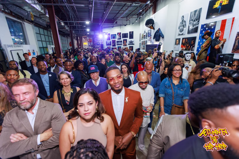 Opening-night visitors fill the gallery between the memorabilia displays.