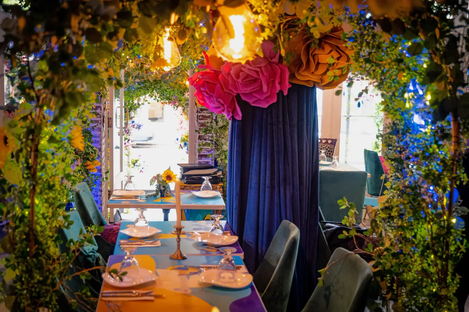 Floral framing and campaign table graphics near the restaurant windows.