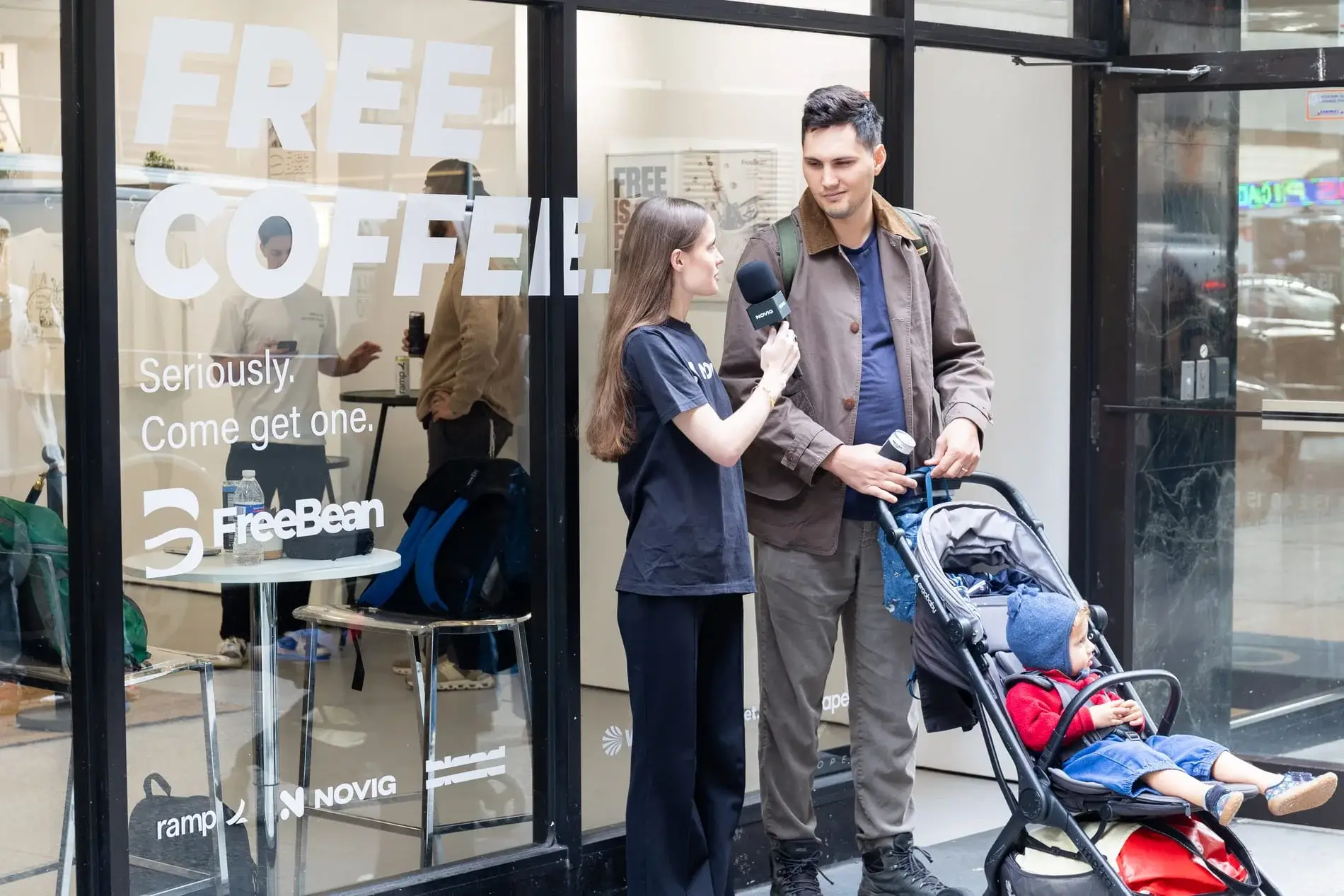 A guest and child stop at the street-level invitation.