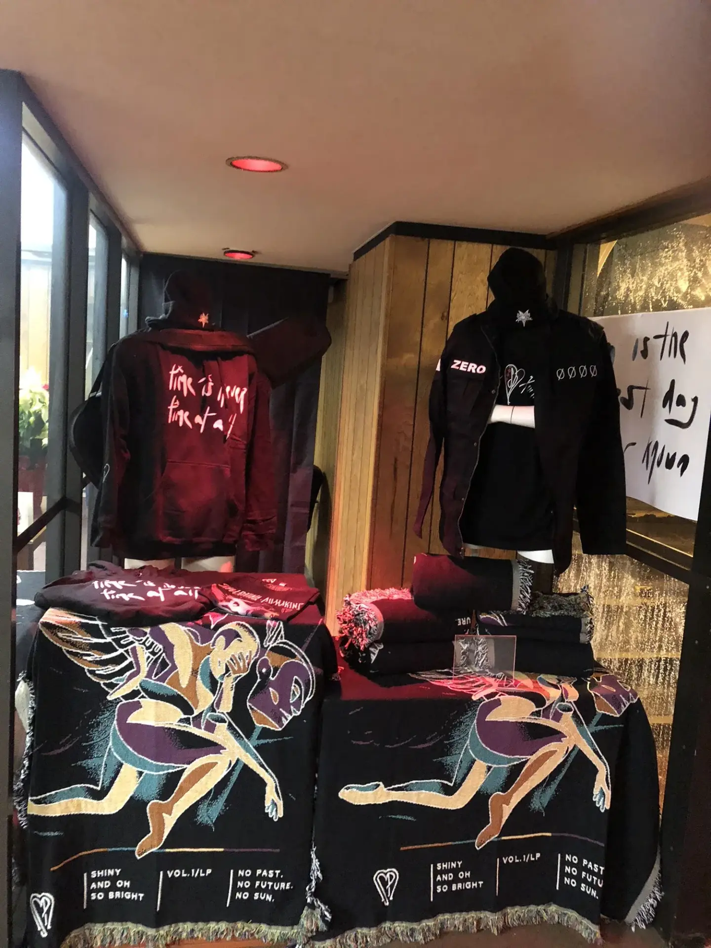 Apparel and graphic textiles carry the band’s identity through the product presentation.