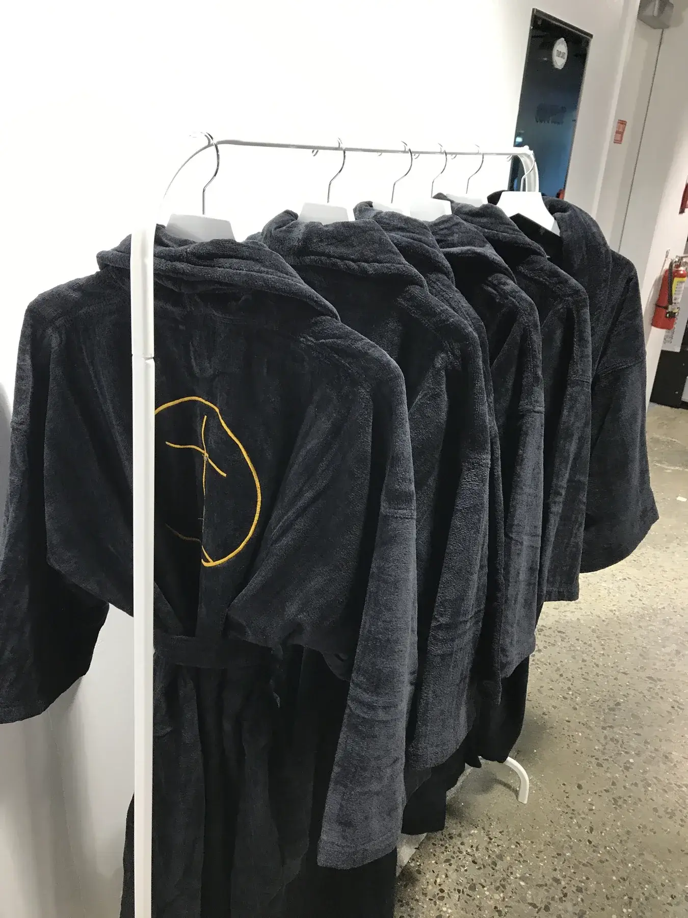 Embroidered Traplord robes presented within the temporary shop.